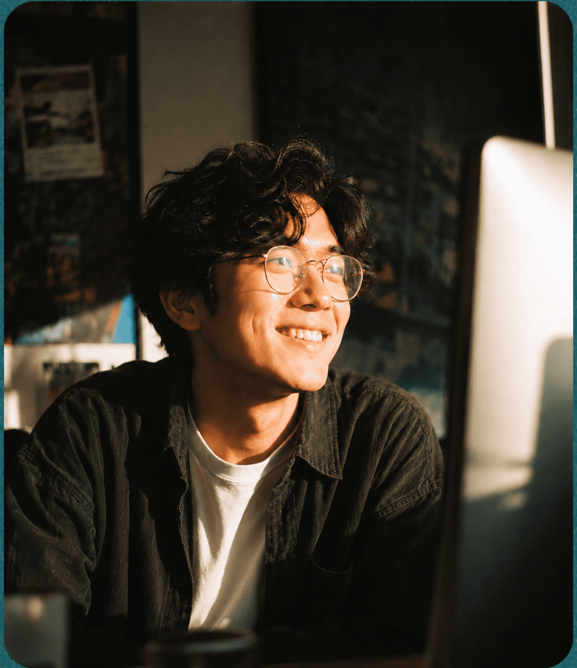 Albert, a full stack engineer, smiling at his desk